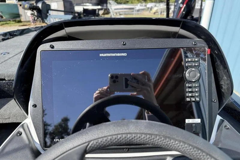 Slide: The Image of Humminbird display on 2026 Skeeter ZXR20 SE boat dashboard, reflecting surroundings. - 17