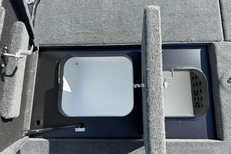 Slide: The Image of 2026 Skeeter ZXR20 SE boat storage compartments with open hatches, showcasing interior space. - 24