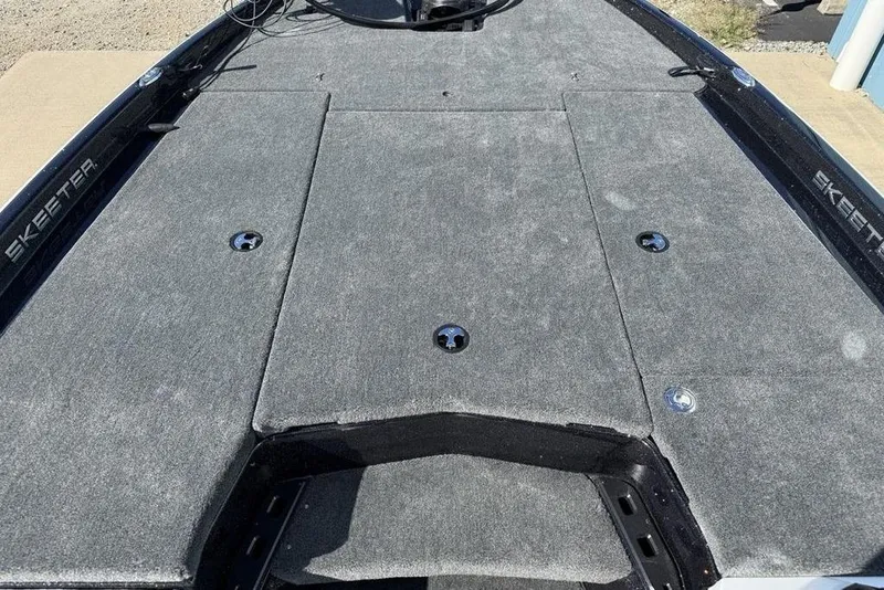 Slide: The Image of 2026 Skeeter ZXR20 SE boat deck with gray carpet and storage compartments. - 5