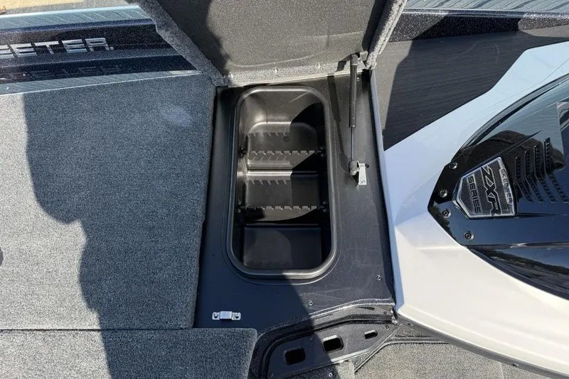 Slide: The Image of 2026 Skeeter ZXR20 SE boat storage compartment with open lid and visible interior. - 9