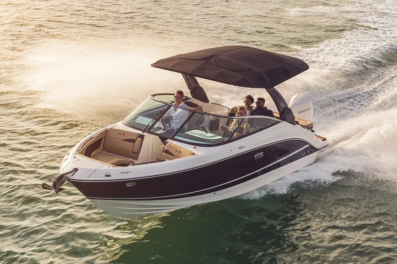 The Image of 2023 Sea Ray SLX 260 Outboard cruising on water at sunset. - 0