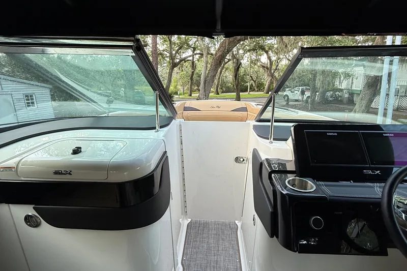 Slide: The Image of 2023 Sea Ray SLX 260 Outboard boat interior with modern dashboard and seating. - 14