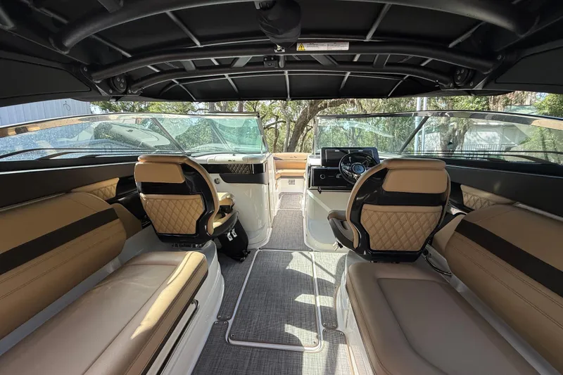 Slide: The Image of Interior view of 2023 Sea Ray SLX 260 Outboard, featuring luxurious seating and modern dashboard. - 16