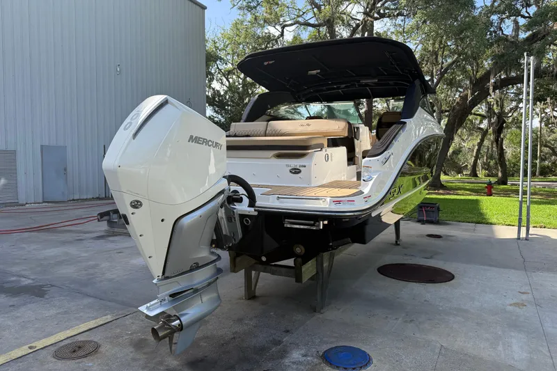 Slide: The Image of 2023 Sea Ray SLX 260 Outboard boat with Mercury engine, docked outdoors. - 3