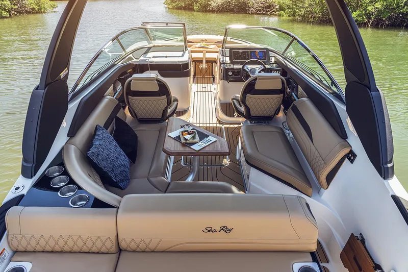 Slide: The Image of 2023 Sea Ray SLX 260 Outboard interior with luxurious seating and modern dashboard. - 8