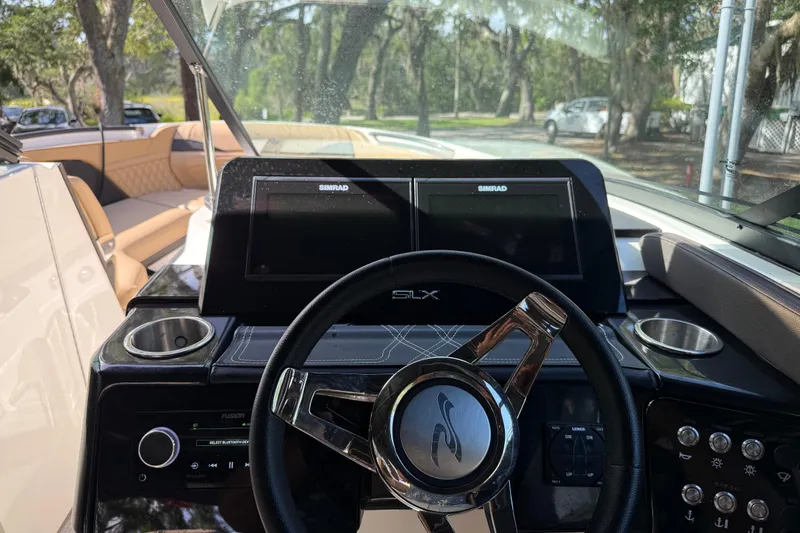 Slide: The Image of 2023 Sea Ray SLX 260 Outboard helm with dual Simrad displays and luxurious seating. - 9