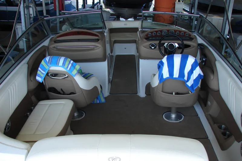 Slide: The Image of Interior of a 2011 Cobalt 232 boat with striped towels on seats. - 11