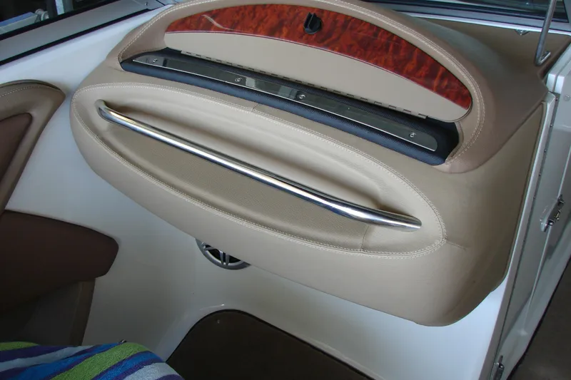 Slide: The Image of Interior of a 2011 Cobalt 232 boat featuring a sleek, modern design with a chrome handle. - 13