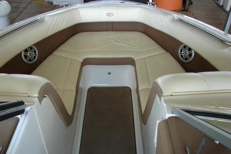 Slide: The Image of Interior of 2011 Cobalt 232 boat with beige and brown seating. - 14