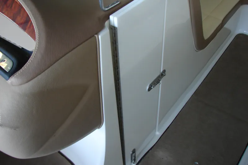 Slide: The Image of Interior view of a 2011 Cobalt 232 boat, featuring beige and white seating. - 16