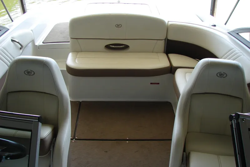 Slide: The Image of Interior of a 2011 Cobalt 232 boat with beige seating and carpeted floor. - 17