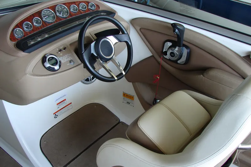 Slide: The Image of 2011 Cobalt 232 boat interior with steering wheel and control panel. - 18