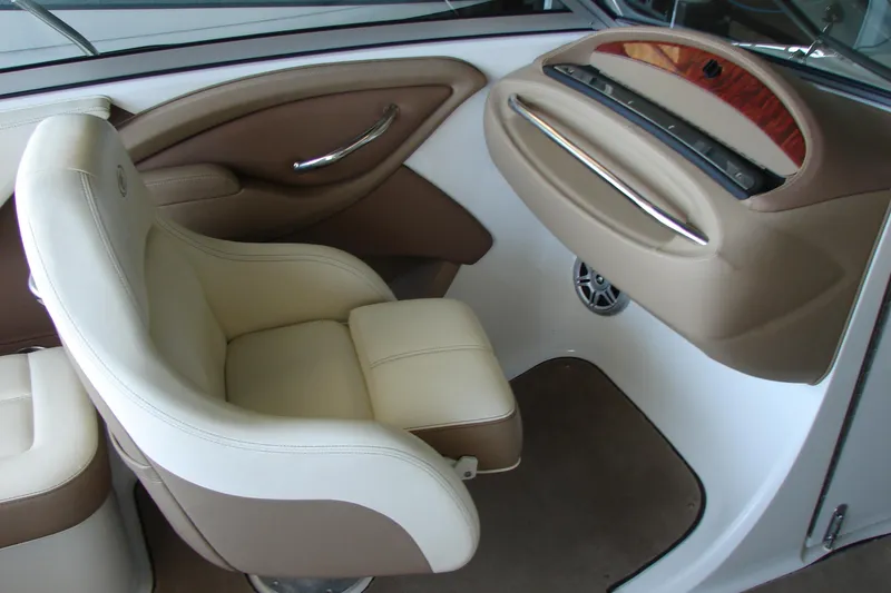 Slide: The Image of Luxurious interior of a 2011 Cobalt 232 boat with beige leather seating. - 19