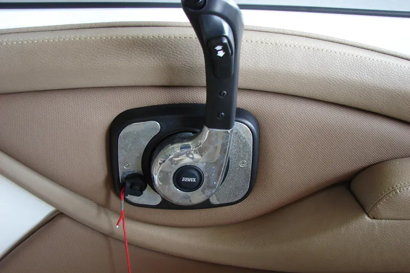 Slide: The Image of 2011 Cobalt 232 boat throttle control on beige interior panel. - 31