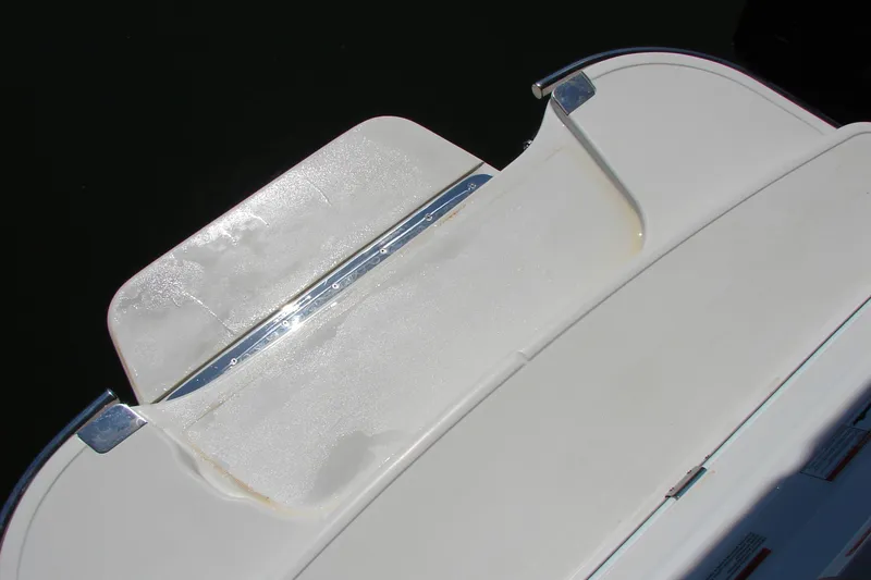 Slide: The Image of 2011 Cobalt 232 boat swim platform with white surface and metal trim. - 36