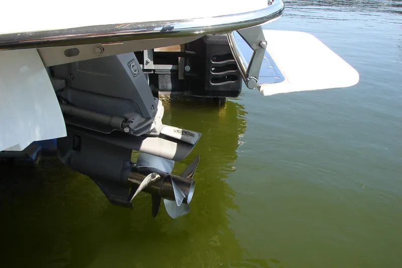Slide: The Image of Rear view of a 2011 Cobalt 232 boat's propeller and swim platform in water. - 37