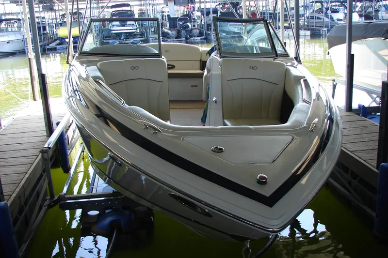 Slide: The Image of 2011 Cobalt 232 boat docked in marina, showcasing sleek design and spacious interior. - 8