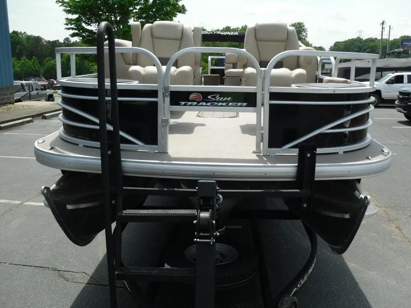 Slide: The Image of 2023 Sun Tracker Sportfish™ 24 XP3 pontoon boat, front view in a parking lot. - 10