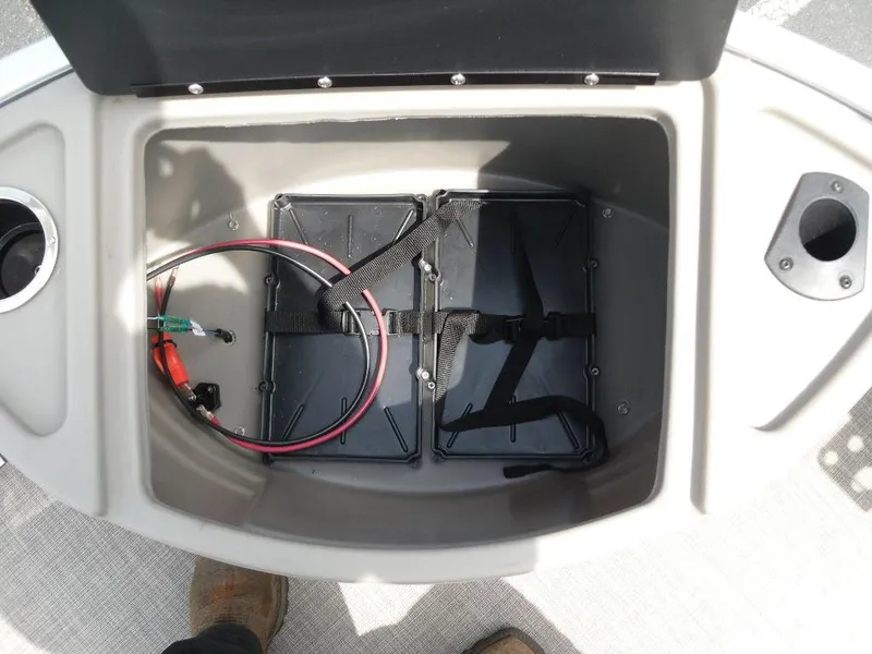 Slide: The Image of 2023 Sun Tracker Sportfish™ 24 XP3 storage compartment with wiring and cup holders. - 19