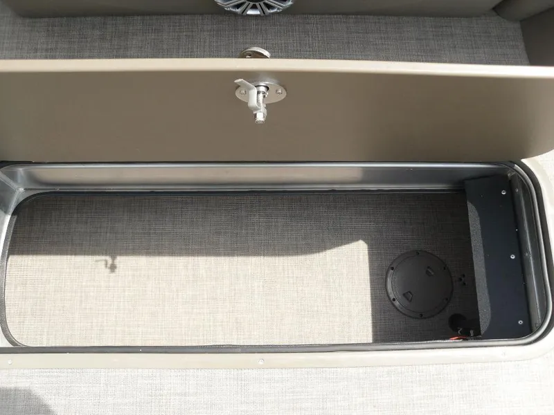 Slide: The Image of Storage compartment on 2023 Sun Tracker Sportfish™ 24 XP3 boat, open with beige interior. - 24
