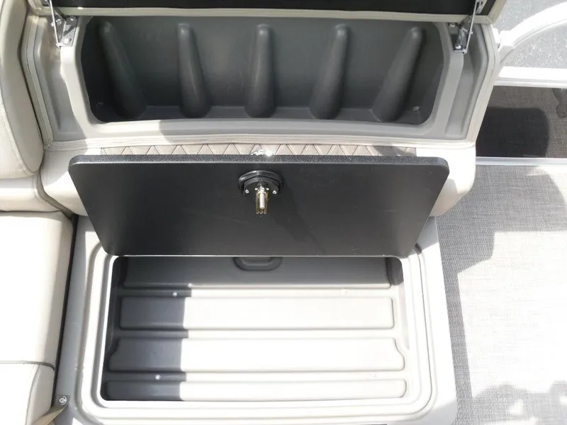Slide: The Image of 2023 Sun Tracker Sportfish™ 24 XP3 storage compartment with secure lock and organized interior. - 27