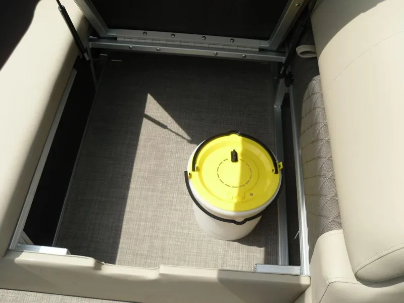 Slide: The Image of 2023 Sun Tracker Sportfish™ 24 XP3 storage compartment with a yellow-lidded container. - 38