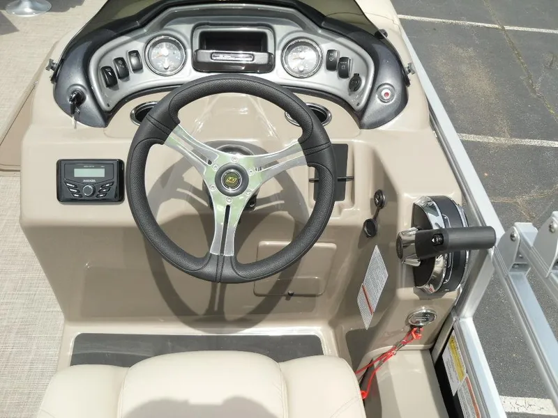 Slide: The Image of 2023 Sun Tracker Sportfish™ 24 XP3 boat dashboard with steering wheel and controls. - 40