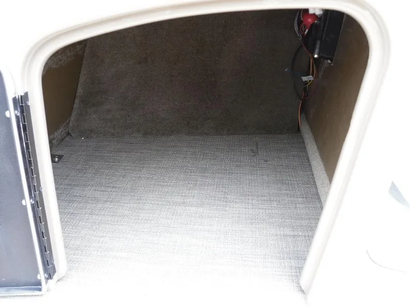 Slide: The Image of Storage compartment of 2023 Sun Tracker Sportfish™ 24 XP3 boat, featuring carpeted interior. - 44