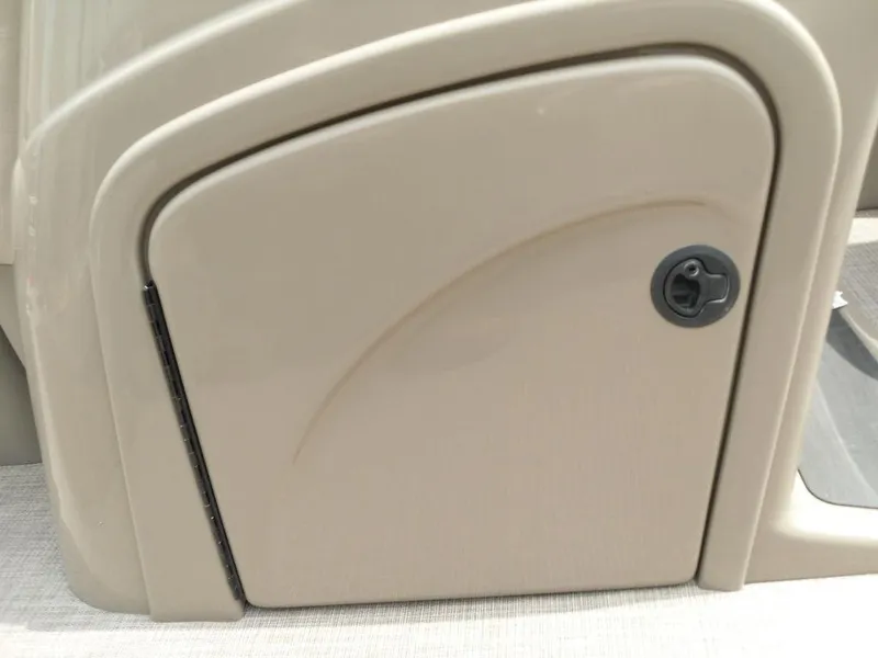Slide: The Image of 2023 Sun Tracker Sportfish™ 24 XP3 storage compartment with beige finish and lock. - 45