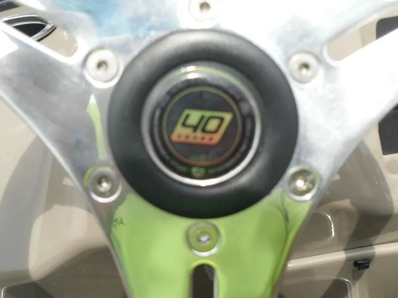 Slide: The Image of Steering wheel of 2023 Sun Tracker Sportfish™ 24 XP3 boat, featuring a 40 HP emblem. - 46