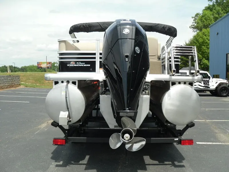 Slide: The Image of 2023 Sun Tracker Sportfish™ 24 XP3 pontoon boat, rear view with powerful outboard motor. - 5