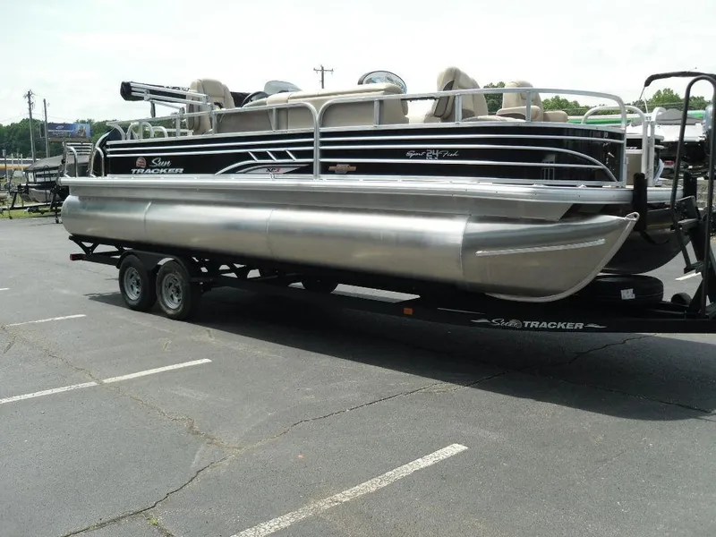 Slide: The Image of 2023 Sun Tracker Sportfish™ 24 XP3 pontoon boat on a trailer in a parking lot. - 7