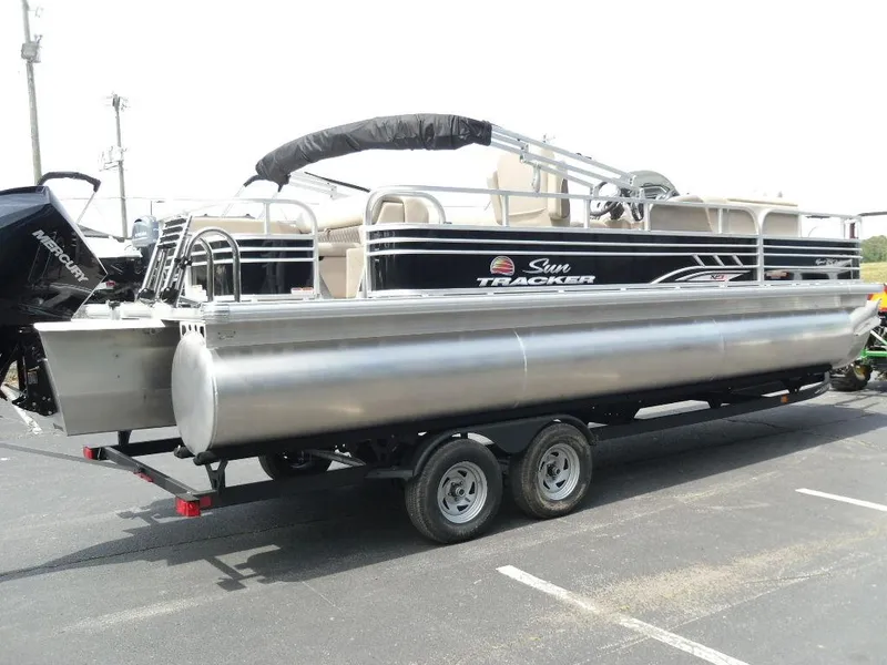 Slide: The Image of 2023 Sun Tracker Sportfish™ 24 XP3 pontoon boat on trailer in parking lot. - 8