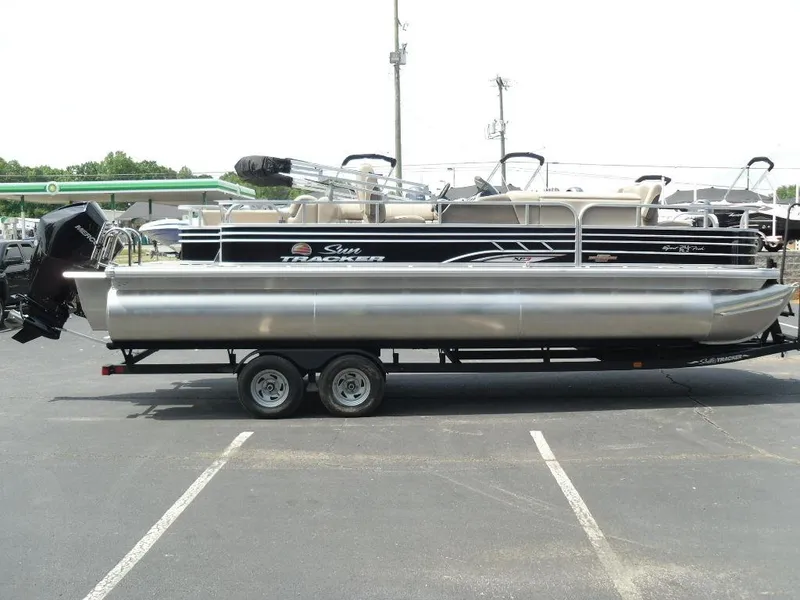 Slide: The Image of 2023 Sun Tracker Sportfish™ 24 XP3 pontoon boat on trailer in parking lot. - 9