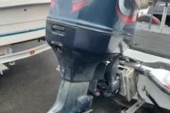 Slide: The Image of Outboard motor on a 2000 Javelin 20 Renegade boat, parked on a trailer. - 11