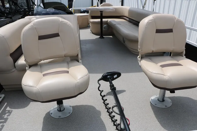 Slide: The Image of 2017 Sun Tracker Fishing Barge 20 DLX interior with beige seating and fishing equipment. - 11