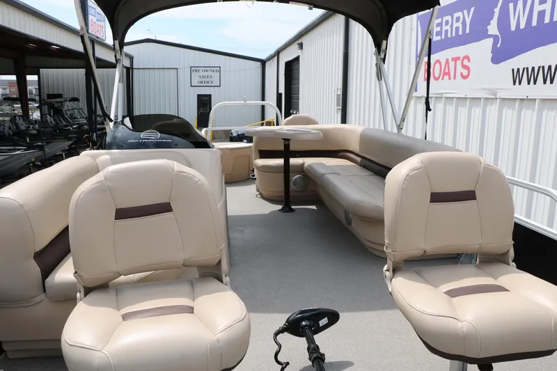 Slide: The Image of 2017 Sun Tracker Fishing Barge 20 DLX interior with beige seating and canopy. - 12