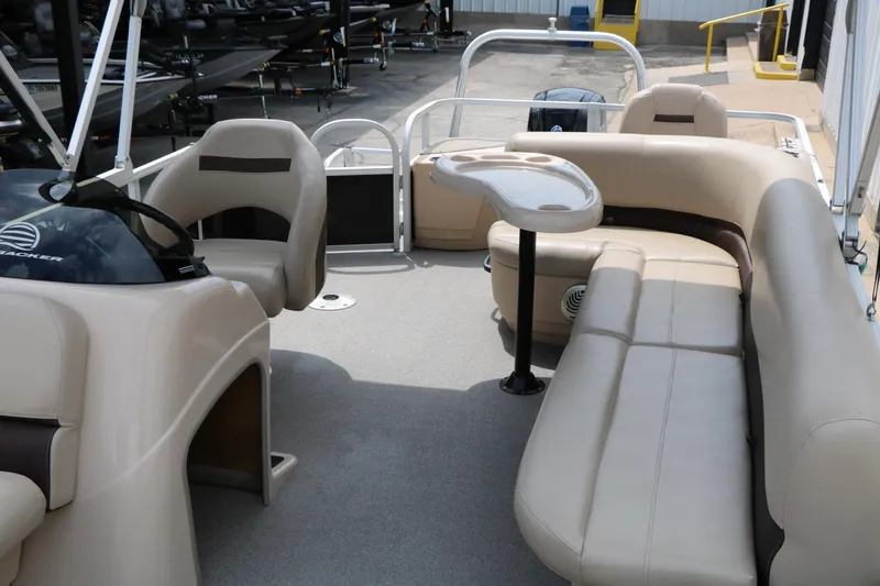 Slide: The Image of 2017 Sun Tracker Fishing Barge 20 DLX interior with beige seating and table. - 14