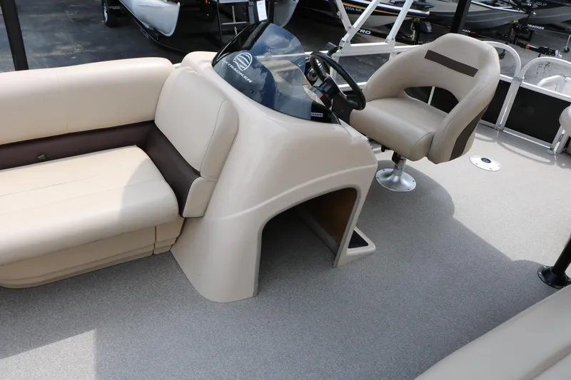 Slide: The Image of 2017 Sun Tracker Fishing Barge 20 DLX interior with beige seating and steering console. - 16