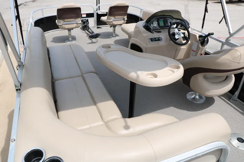 Slide: The Image of 2017 Sun Tracker Fishing Barge 20 DLX interior with beige seating and steering console. - 21