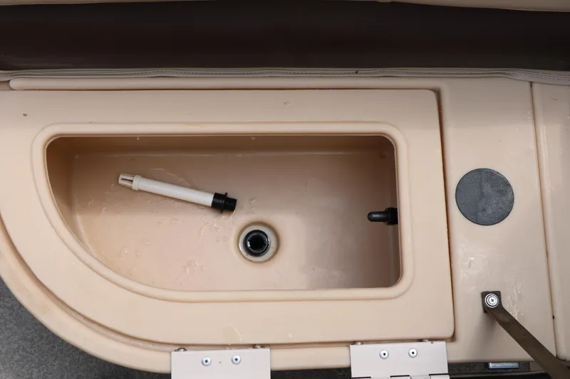 Slide: The Image of 2017 Sun Tracker Fishing Barge 20 DLX livewell interior with drain and aerator components. - 29