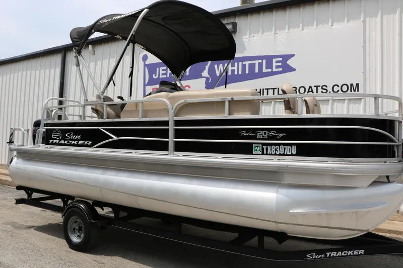 Slide: The Image of 2017 Sun Tracker Fishing Barge 20 DLX pontoon boat on trailer, parked outside dealership. - 3