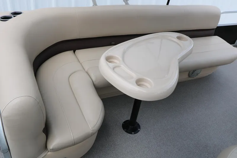 Slide: The Image of 2017 Sun Tracker Fishing Barge 20 DLX interior with beige seating and table. - 32