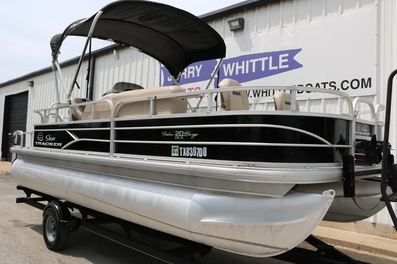 Slide: The Image of 2017 Sun Tracker Fishing Barge 20 DLX pontoon boat on trailer outside dealership. - 4