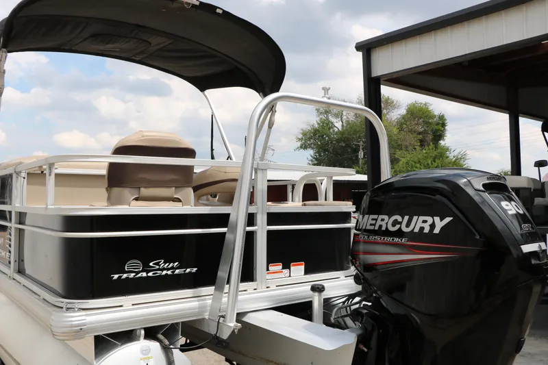 Slide: The Image of 2017 Sun Tracker Fishing Barge 20 DLX with Mercury outboard motor, docked under a canopy. - 9