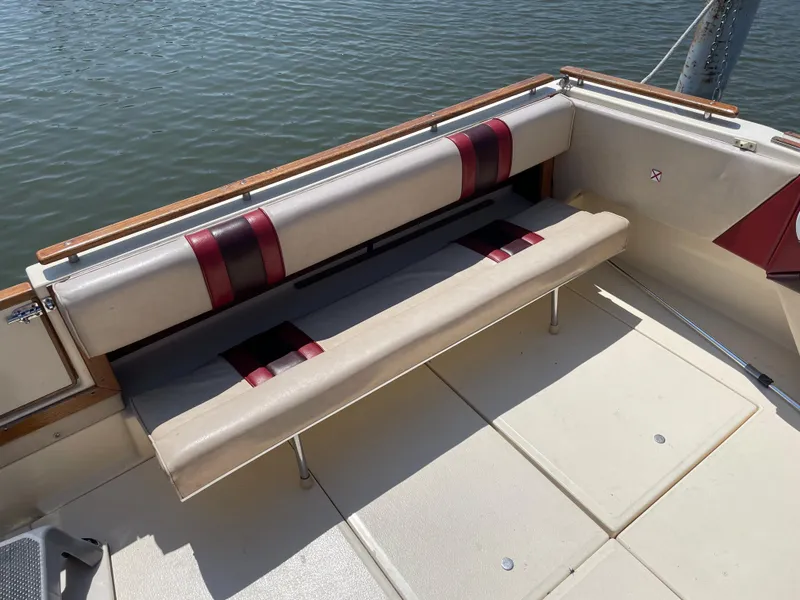 Slide: The Image of 1986 Sea Ray 268 Weekender boat interior with cushioned seating by the water. - 11