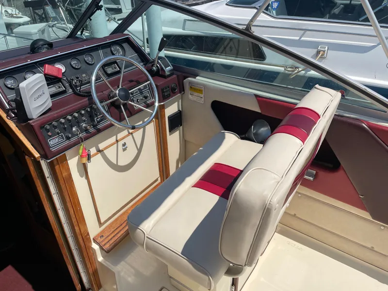 Slide: The Image of 1986 Sea Ray 268 Weekender boat interior with steering wheel and seating. - 12