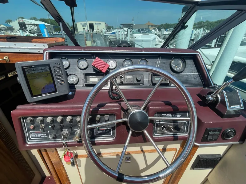 Slide: The Image of 1986 Sea Ray 268 Weekender dashboard with steering wheel and navigation instruments. - 15