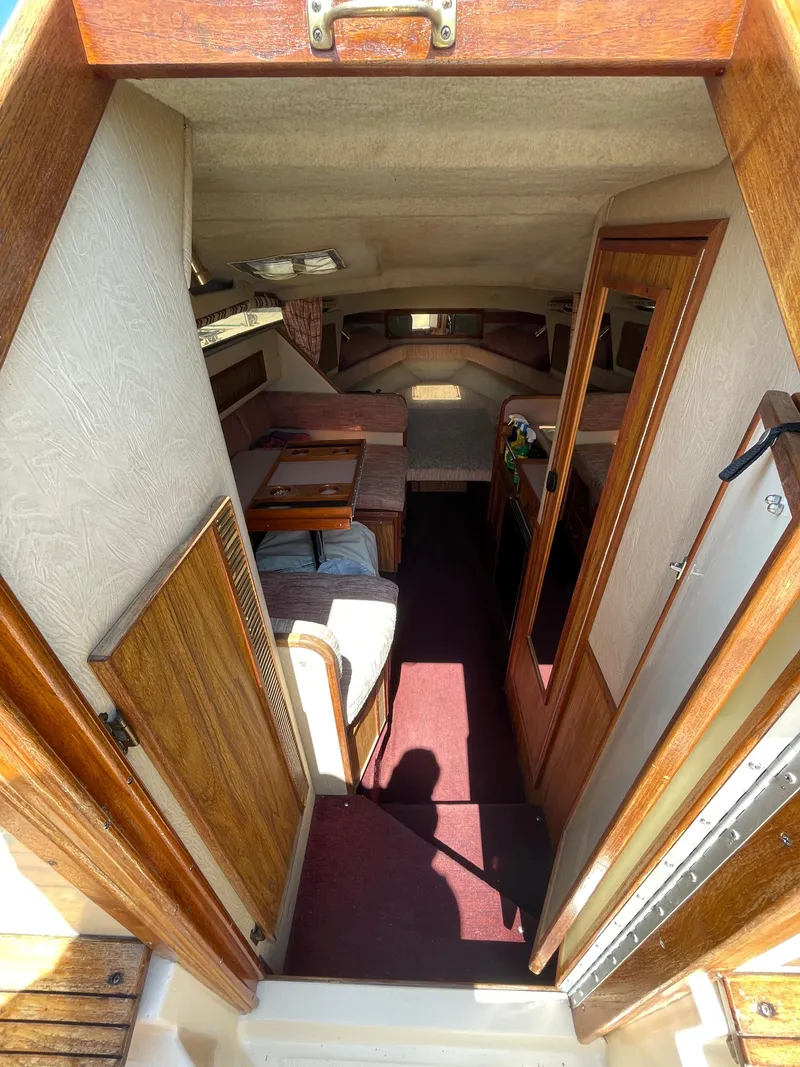 Slide: The Image of Interior view of 1986 Sea Ray 268 Weekender boat, featuring cozy cabin and wooden accents. - 20