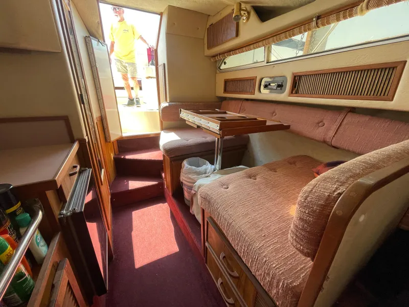 Slide: The Image of Interior of 1986 Sea Ray 268 Weekender boat with seating and table. - 26